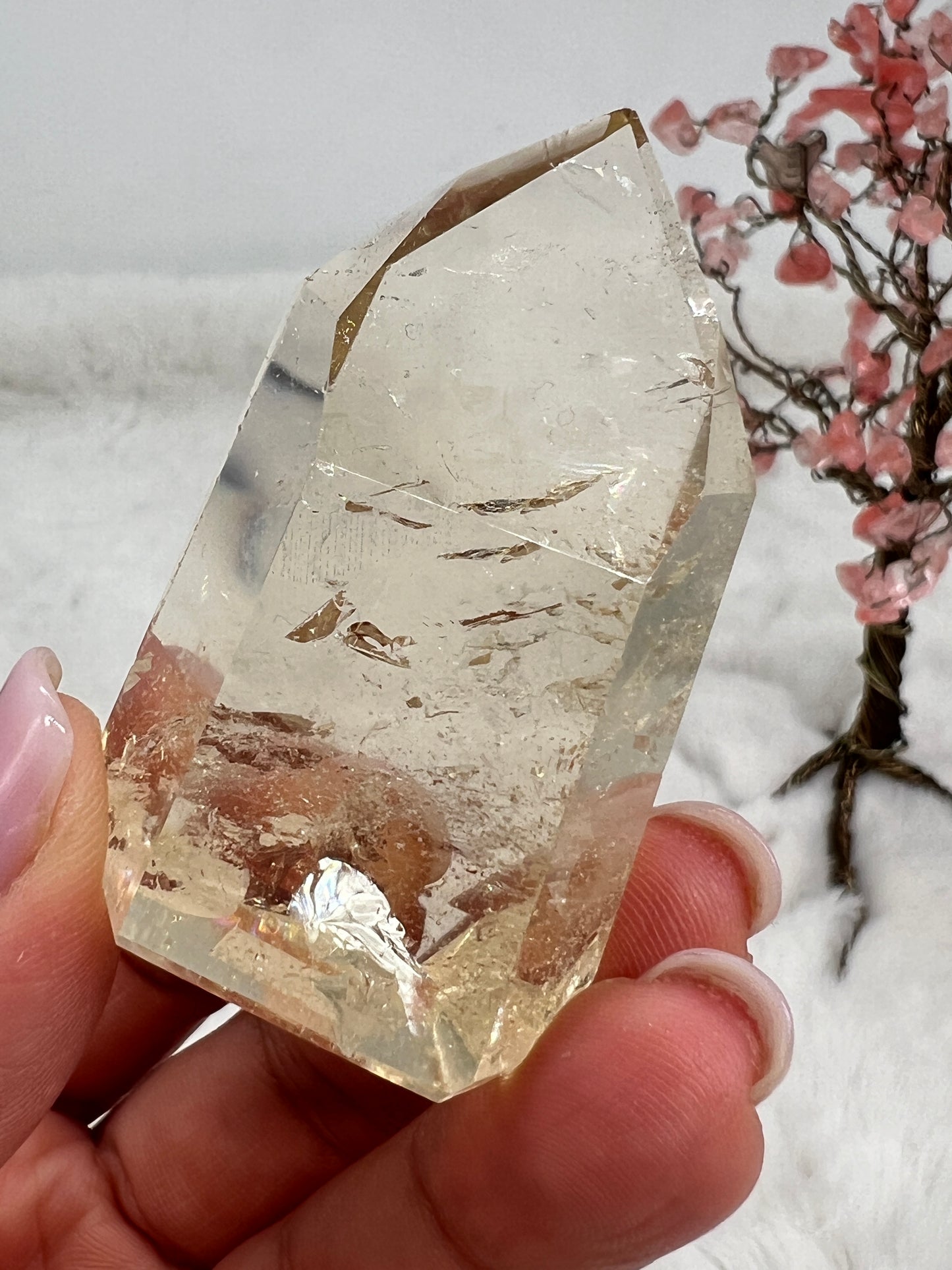 Natural polished citrine point with pale honey and golden hues