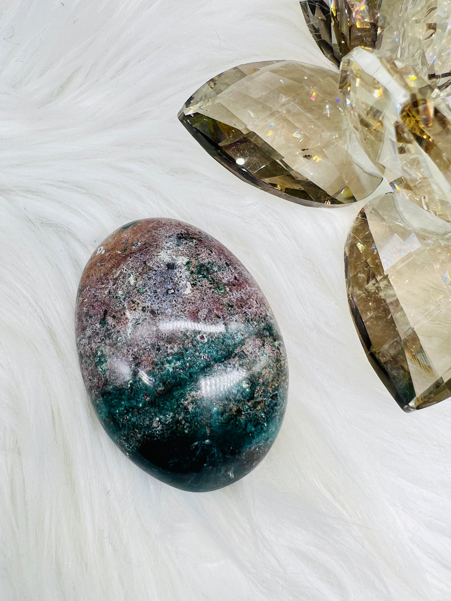 An Ocean Jasper palmstone with mottles of purple and green colors, like a flower painting.