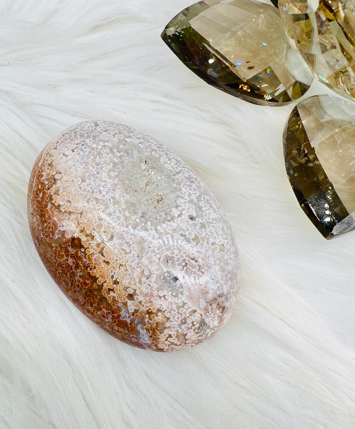 An Ocean Jasper Palmstone with peach orbicular patterns resembling ocean waves.